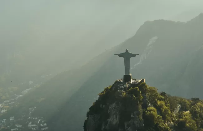 Aerial view of Christ the Redeemer statue overlooking the mountains and city of Rio de Janeiro in Brazil.