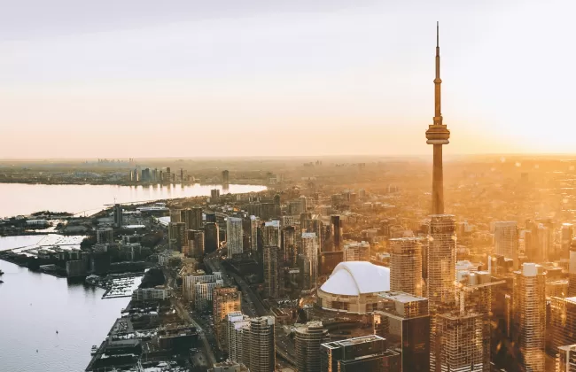Aerial view of Toronto skyline at sunset with the CN Tower and Lake Ontario in Canada.