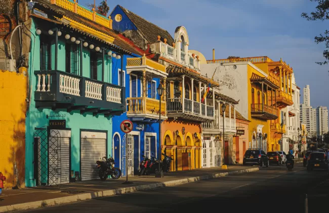 A vibrant street lined with colorful colonial-style houses and shops.