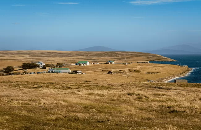 Dry grassy plains with sparse settlements near the coastline.