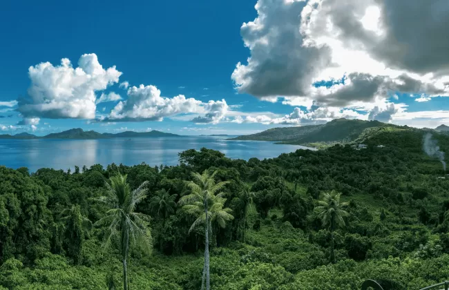 Lush green hills under a cloudy sky.