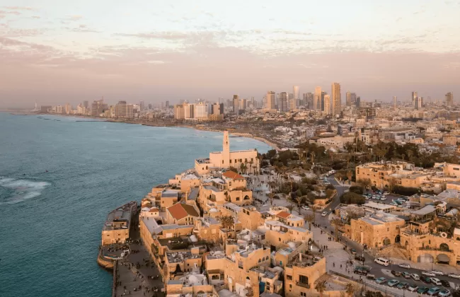 A coastal cityscape of Tel Aviv, Israel, with modern buildings along the Mediterranean.