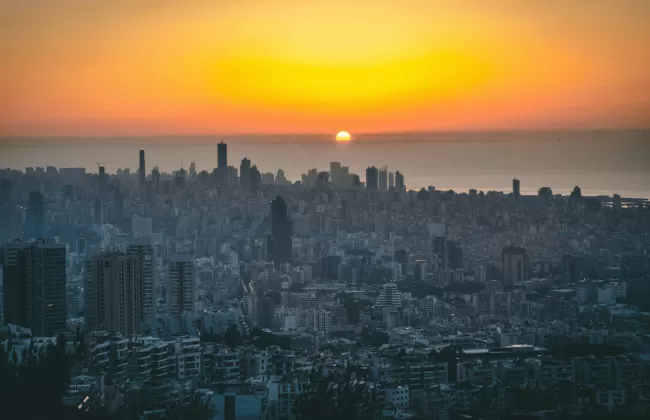 Sunset view over a large city with tall skyscrapers.