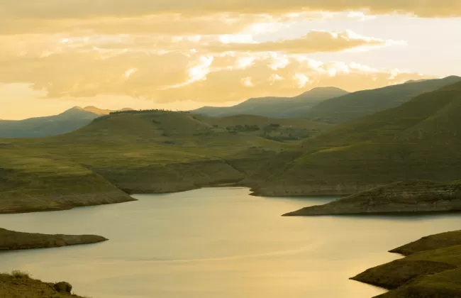 Scenic mountain lake surrounded by rolling hills.