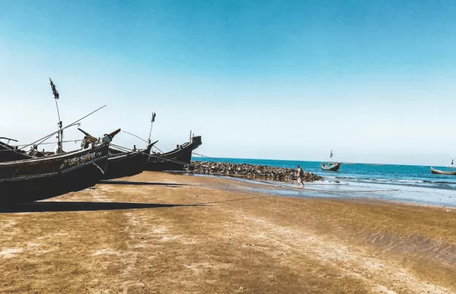 Traditional wooden fishing boats on a sandy beach.