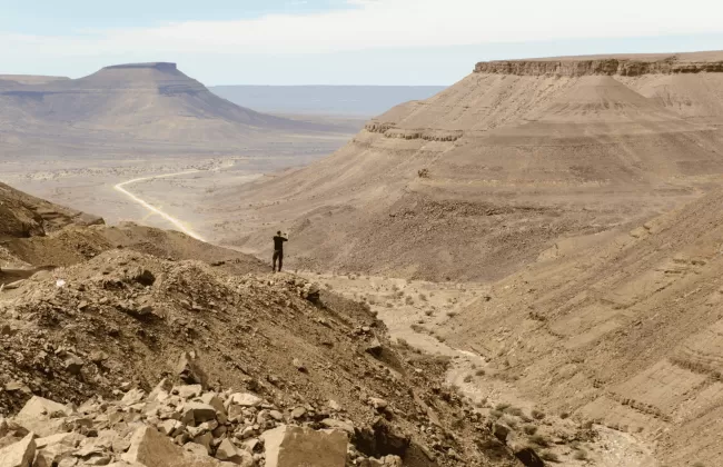 Arid desert landscape with rocky hills.
