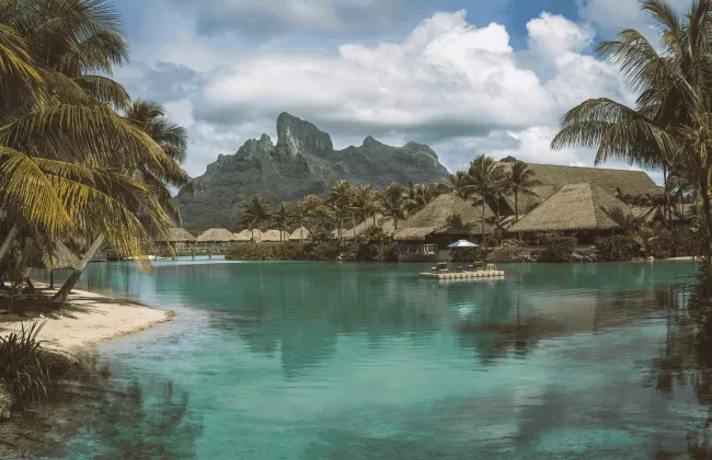 A turquoise lagoon surrounded by steep rocky cliffs.