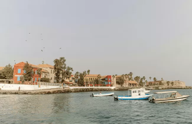 Boats docked along the waterfront of a coastal town.