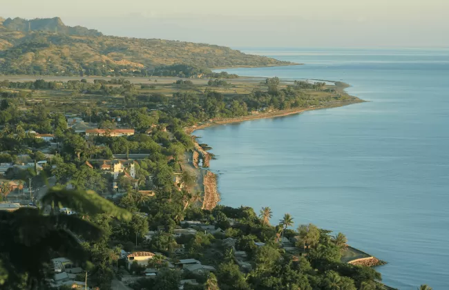A coastal town with houses built on cliffs overlooking the sea.