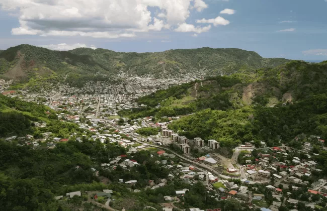 A town nestled in lush green hills.