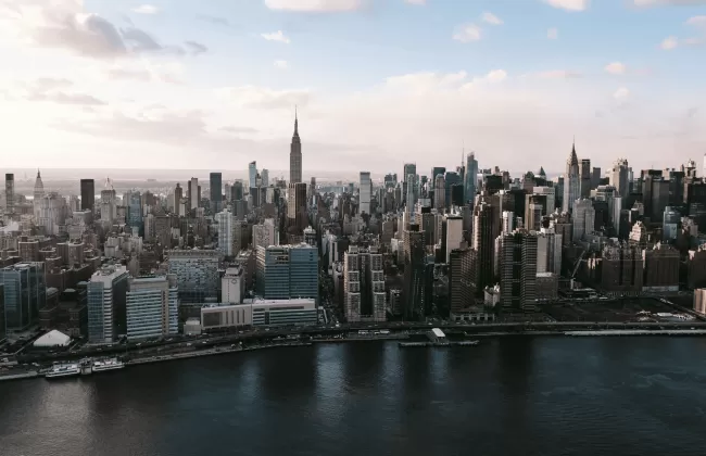 Aerial view of New York City skyline with Manhattan skyscrapers and rivers.
