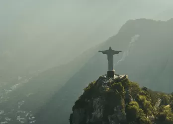 Aerial view of Christ the Redeemer statue overlooking the mountains and city of Rio de Janeiro in Brazil.
