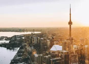 Aerial view of Toronto skyline at sunset with the CN Tower and Lake Ontario in Canada.