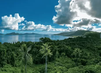 Lush green hills under a cloudy sky.