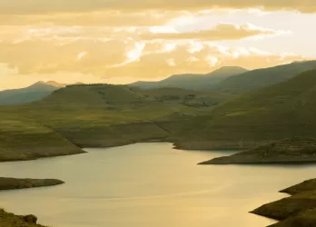 Scenic mountain lake surrounded by rolling hills.