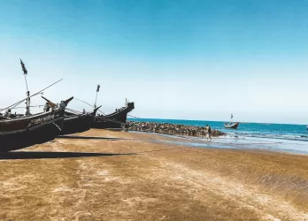 Traditional wooden fishing boats on a sandy beach.