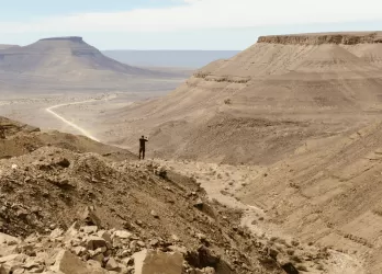Arid desert landscape with rocky hills.