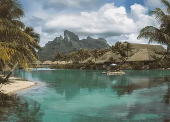 A turquoise lagoon surrounded by steep rocky cliffs.