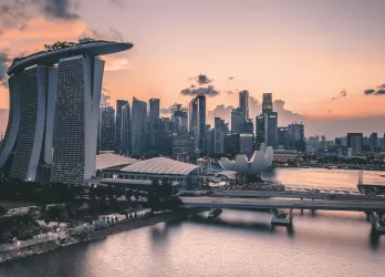 Modern skyline of Singapore with Marina Bay Sands at sunset.