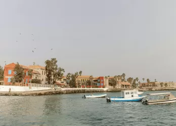 Boats docked along the waterfront of a coastal town.