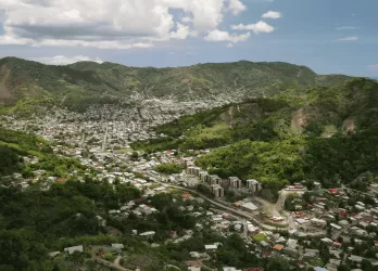 A town nestled in lush green hills.